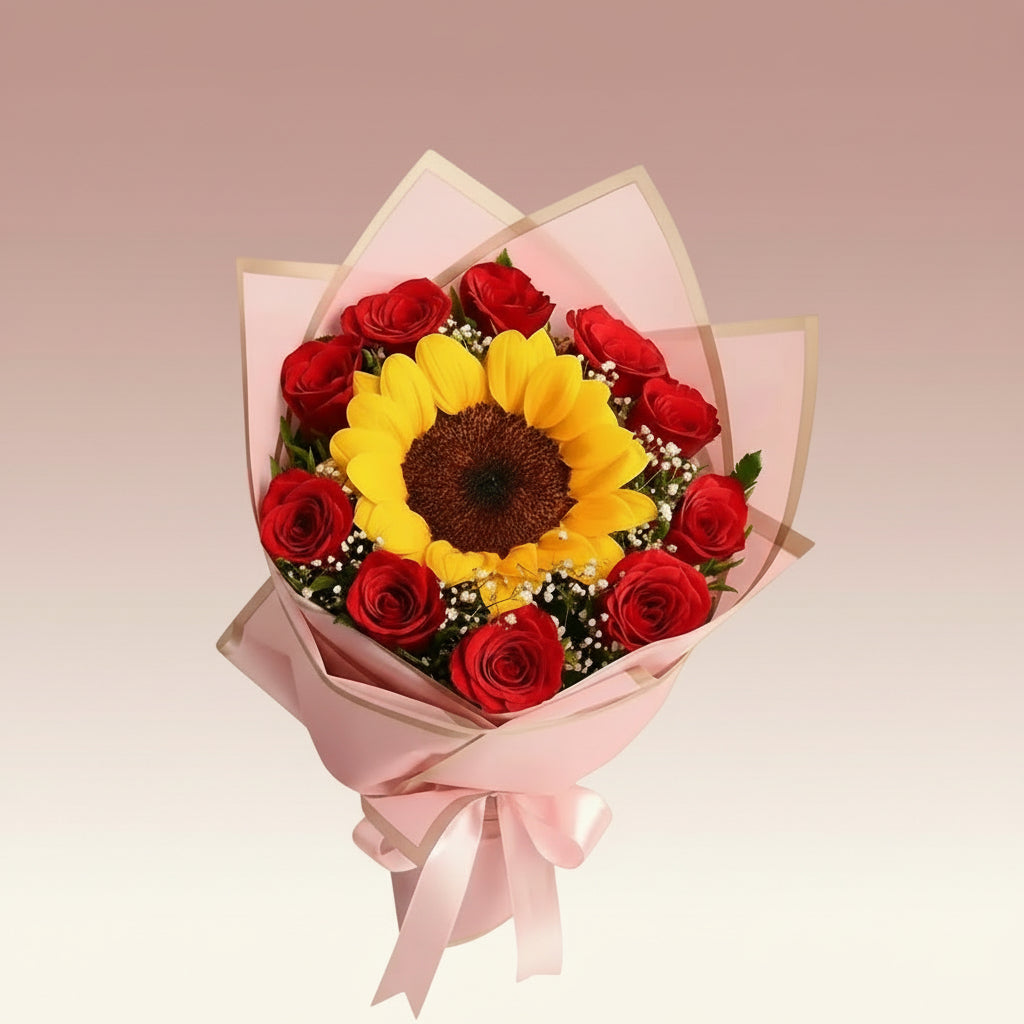 Bouquet of red roses and a sunflower wrapped in pink paper on a yellow background
