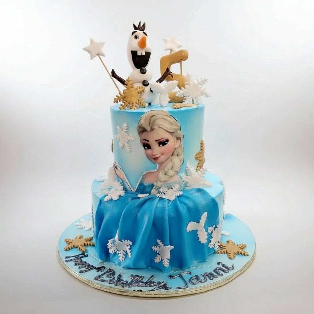 Frozen-themed birthday cake with Elsa and Olaf decorations on a wooden background