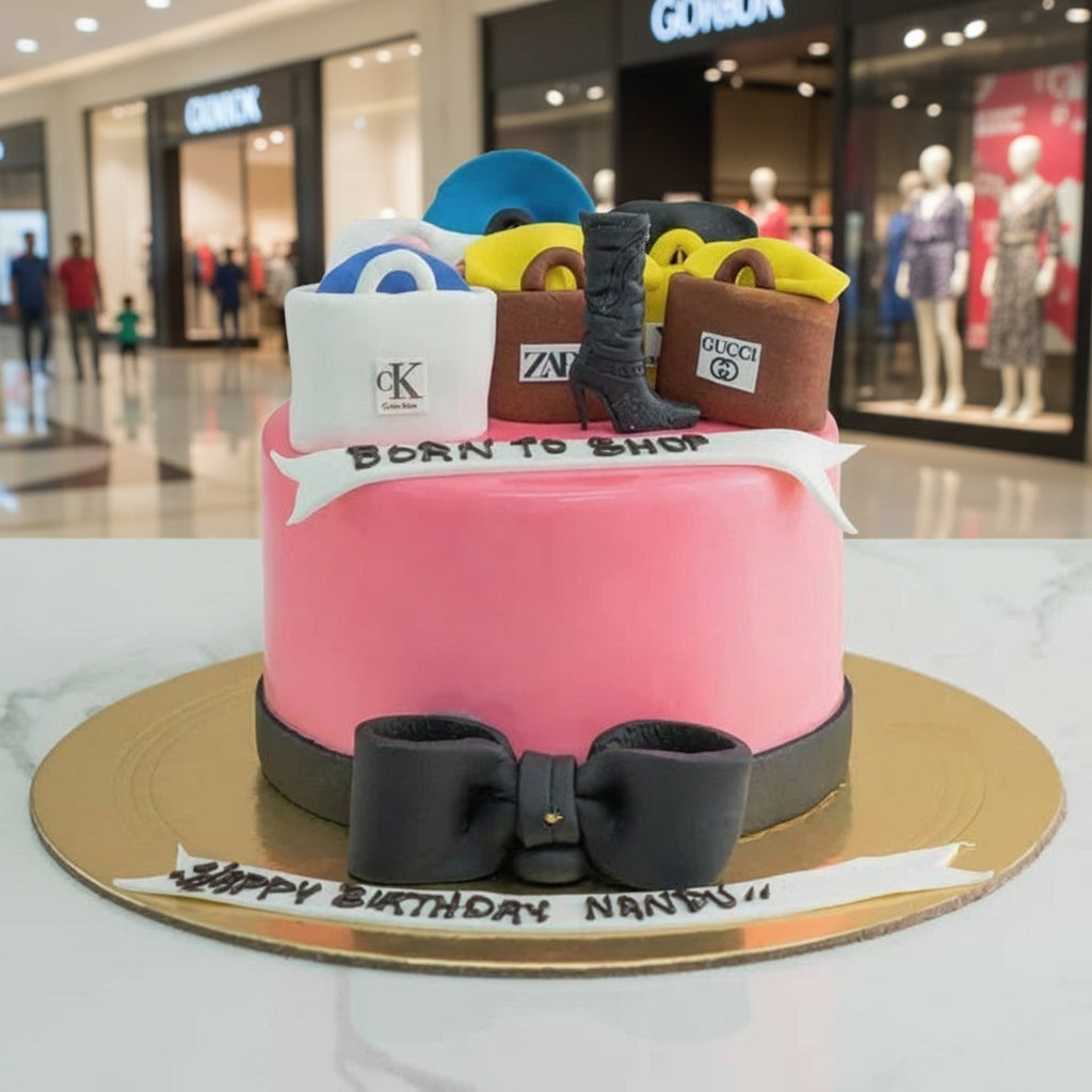 Pink birthday cake with shopping bag decorations on a marble surface